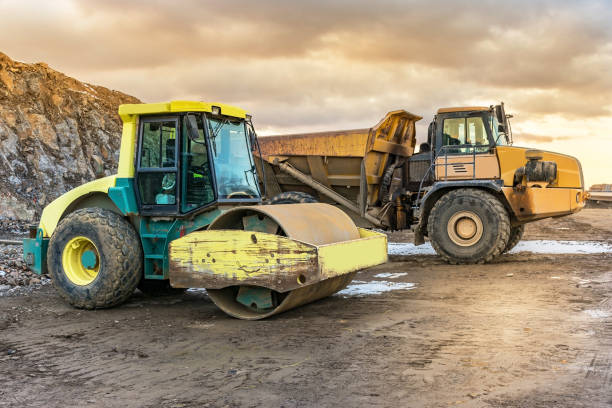 istock Trucks and road roller in the construction of a road 988358496