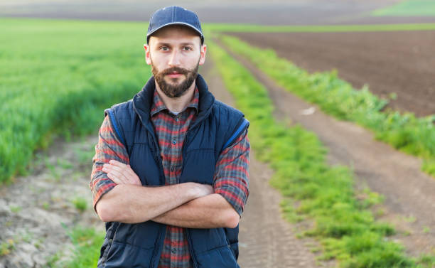 istock Farmer standing with arms crossed 988359100