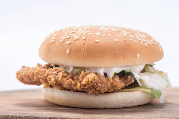 istock Crispy chicken burger with lettuce, cheese, and mayonnaise 988359136