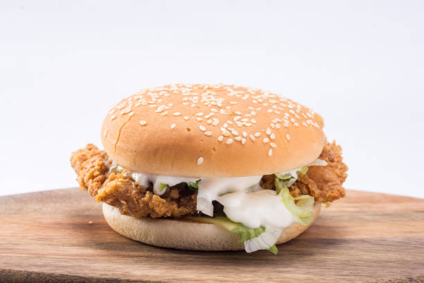 istock Crispy chicken burger with lettuce, cheese, and mayonnaise 988359152