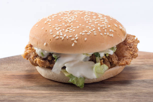 istock Crispy chicken burger with lettuce, cheese, and mayonnaise 988359286