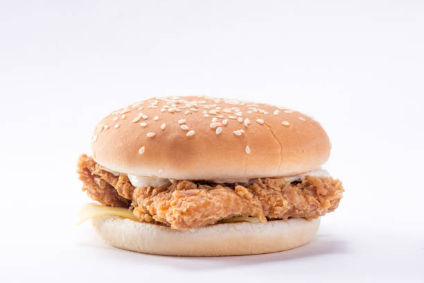 istock Crispy chicken burger with lettuce, cheese, and mayonnaise 988359422
