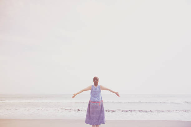 istock Woman relaxed at seaside 988369576