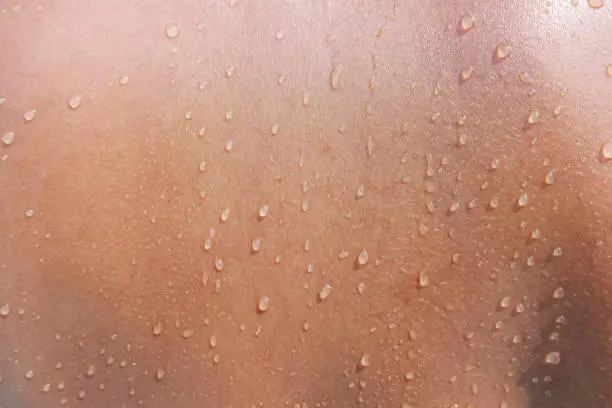 Photo of Water drops on woman skin, close up of wet human skin texture