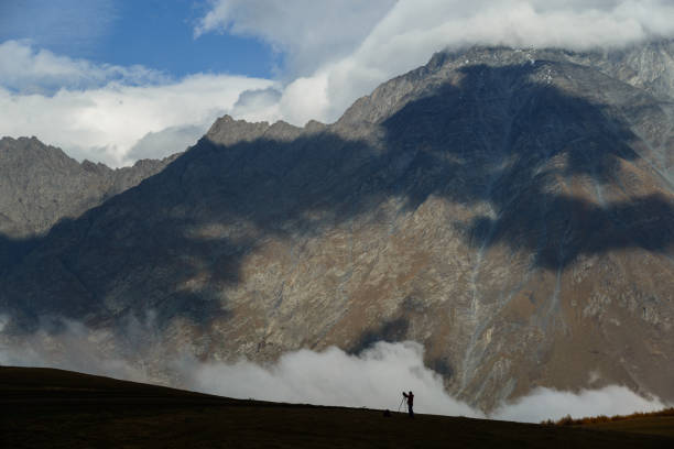 istock Landscape photographer at work in the mountains 988376416