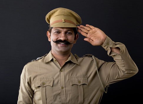 Portrait of Indian police officer saluting