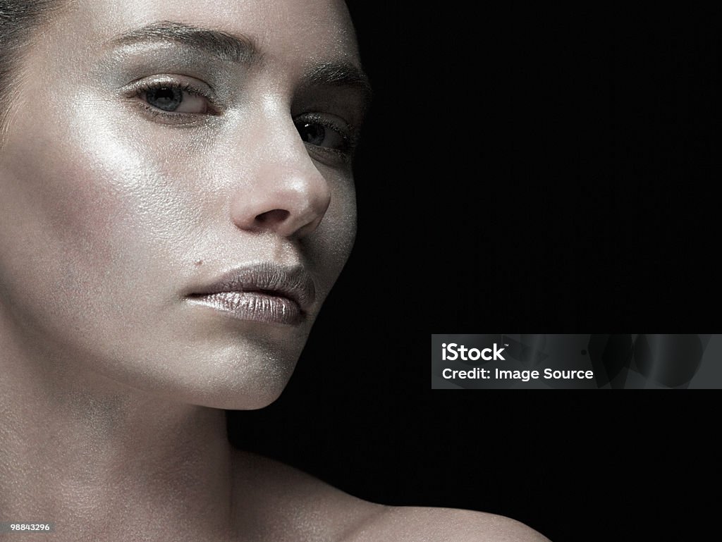 Young woman covered with silver make up  Black Background Stock Photo