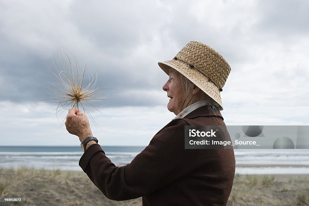 Senior woman on Piha Beach, Auckland  New Zealand Stock Photo