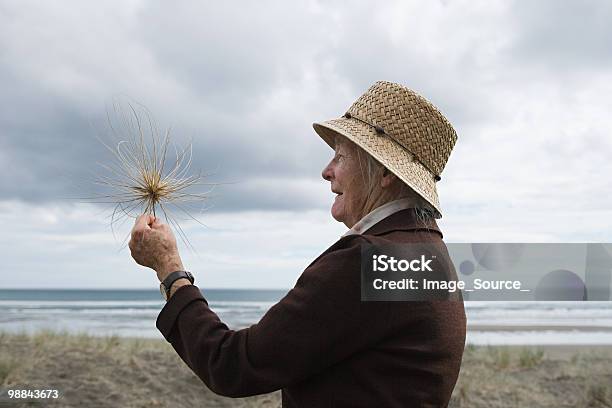 Senior Woman On Piha Beach Auckland Stock Photo - Download Image Now - New Zealand, Senior Adult, People