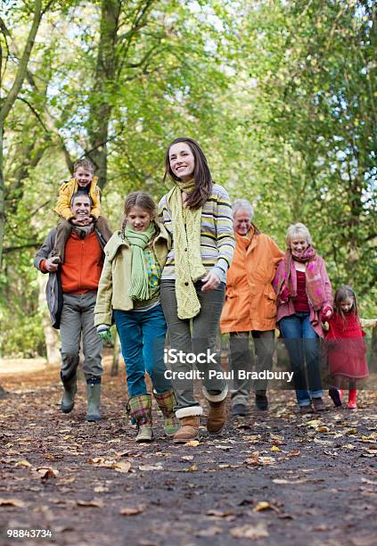 Extended Family Walking Outdoors In Autumn Stock Photo - Download Image Now - Family, Multi-Generation Family, Footpath