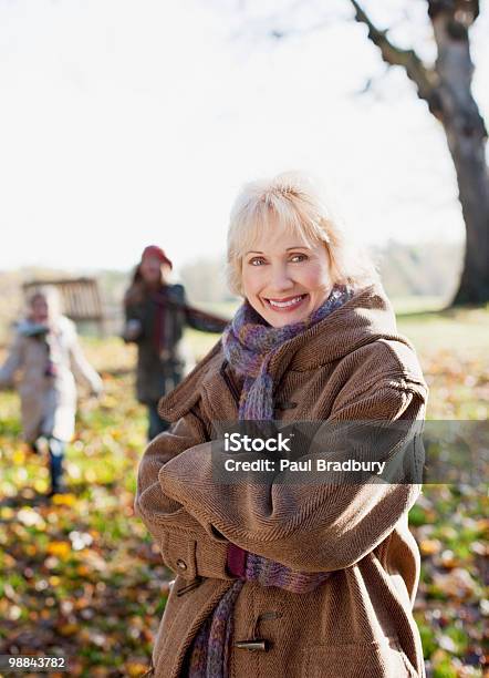 Smiling Woman In Coat Outdoors In Autumn Stock Photo - Download Image Now - One Woman Only, Women, Active Seniors