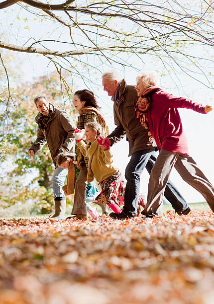 familie läuft im park - grandfather grandson active seniors senior adult stock-fotos und bilder