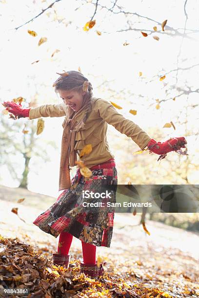 Rir Menina Jogar Na Pilha De Folhas De Outono - Fotografias de stock e mais imagens de Criança - Criança, Dançar, Outono