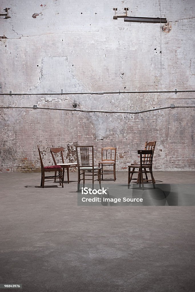 Chairs in empty warehouse  Absence Stock Photo