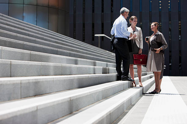 Business people standing on steps outdoors  formal businesswear stock pictures, royalty-free photos & images