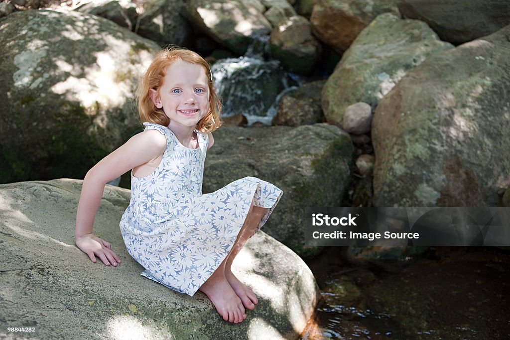 Girl on rocks by river  Cape Town Stock Photo