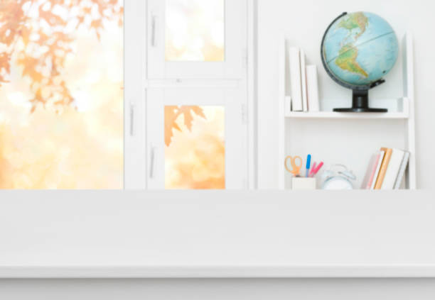 istock White table with blurred background of kids room and window 988443292