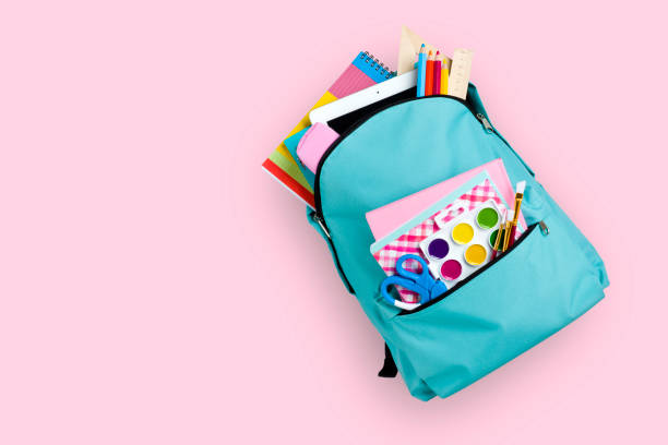 Full school backpack isolated on pink background Full school backpack isolated on pink background school supplies photos stock pictures, royalty-free photos & images
