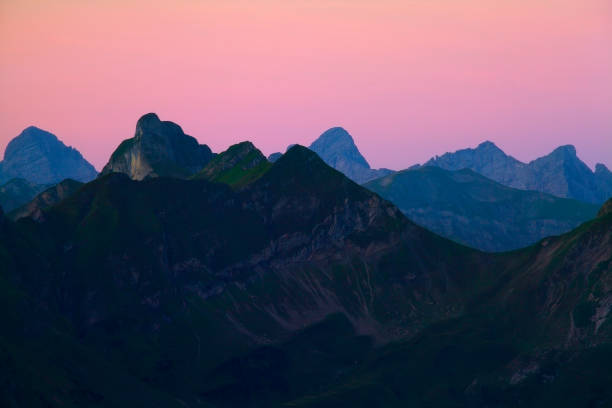 istock mountain silhouette at dawn, Alps 988478746