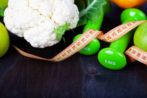 istock Food for diet and dumbbells 988486304