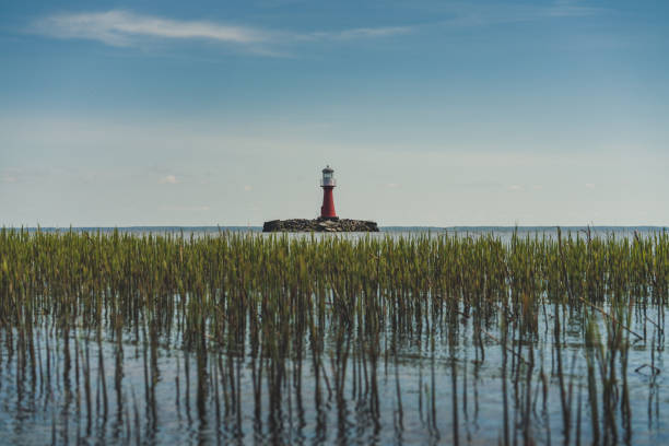 Manavgat harbour entrance and lighthouse with man fishing, bad weather