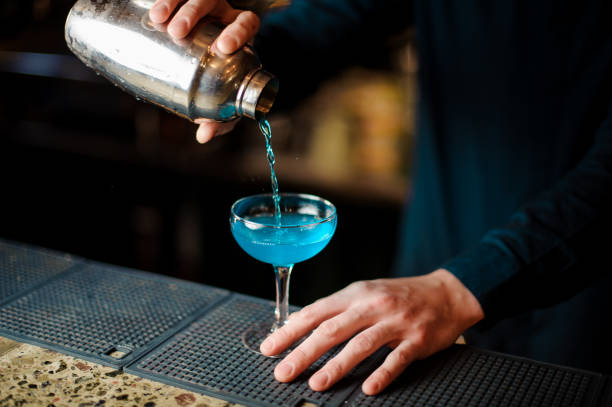 istock barman pours an alcohol cocktail from the shaker 988488964