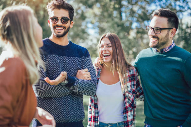 istock Group of young people walking through park 988489964