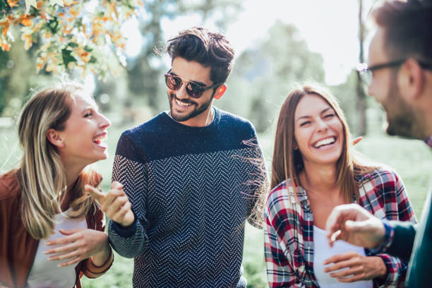 istock Group of young people walking through park 988490016