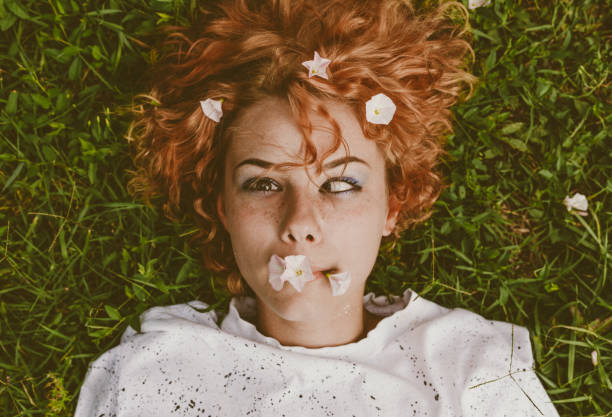 istock Woman lying down in the grass 988490840