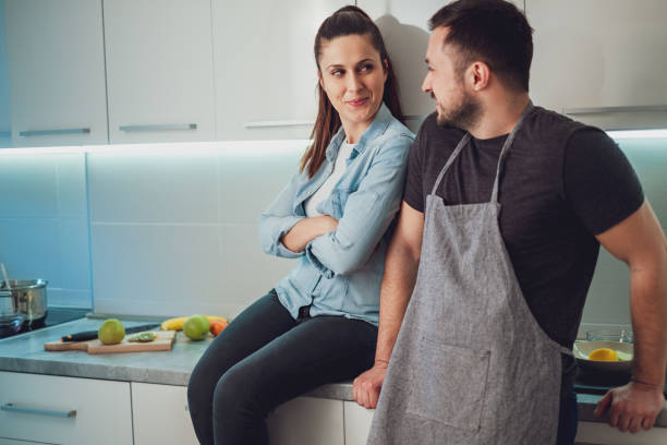 istock Couple flirting and smiling in the kitchen 988505896