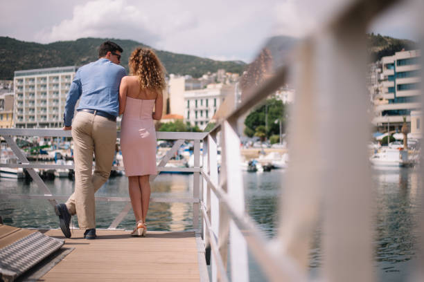 istock Young couple enjoying the views from the marina 988507370