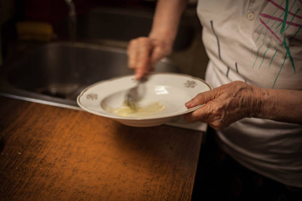 istock Grandmother preparing batter for pancakes. 988513000