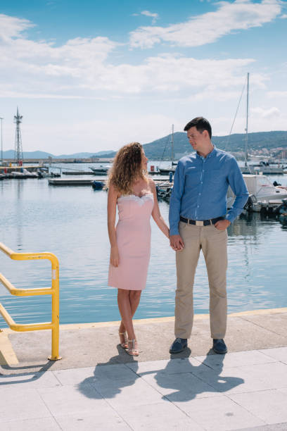 istock Couple holding hands by the sea 988514716