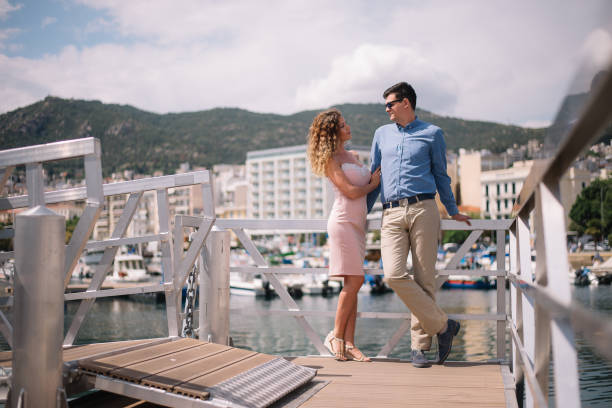 istock Young couple enjoying the views from the marina 988518556