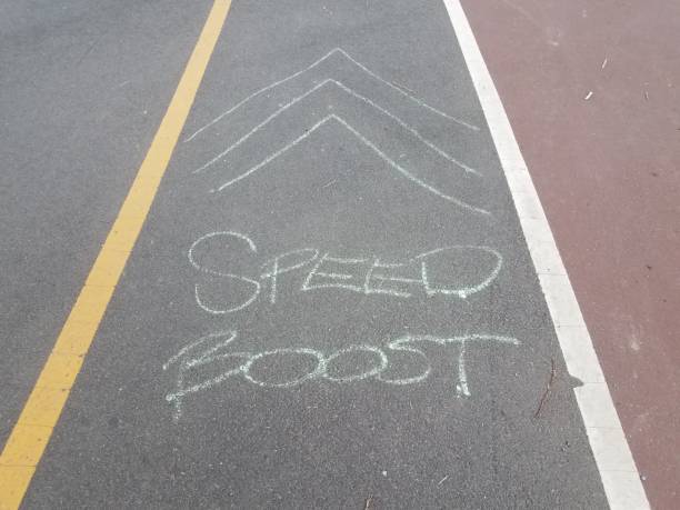 istock asphalt bike trail or path with speed boost and arrows on the ground 988525276