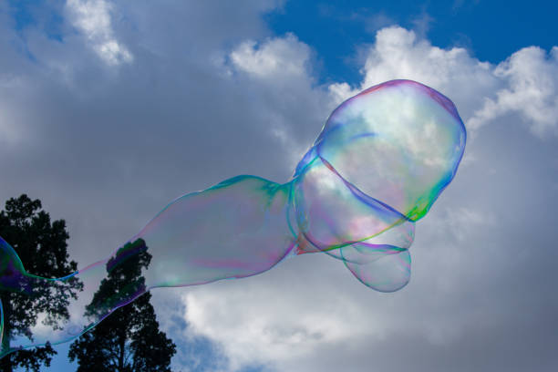 istock soap bubbles against sun and sky as abstract background or wallpaper 988525438