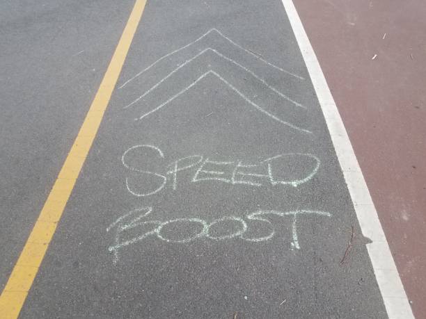istock asphalt bike trail or path with speed boost and arrows on the ground 988525444