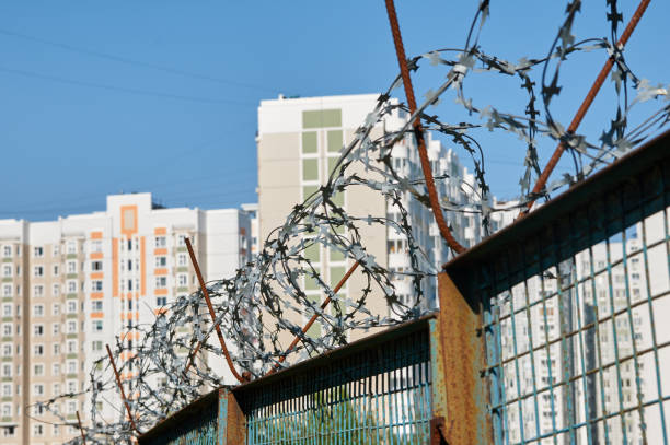 istock houses behind a barbed wire fence 988526218