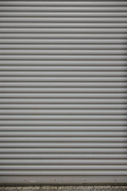 istock Metal roller shutter door of store closed 988531526