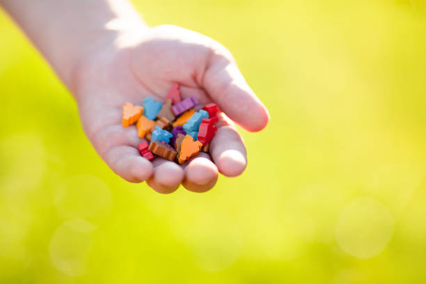 A handful of multicolored meeple figurines