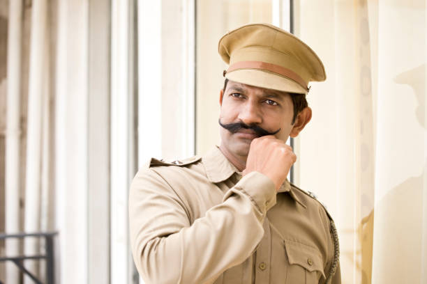 istock Police officer holding his mustache 988535954