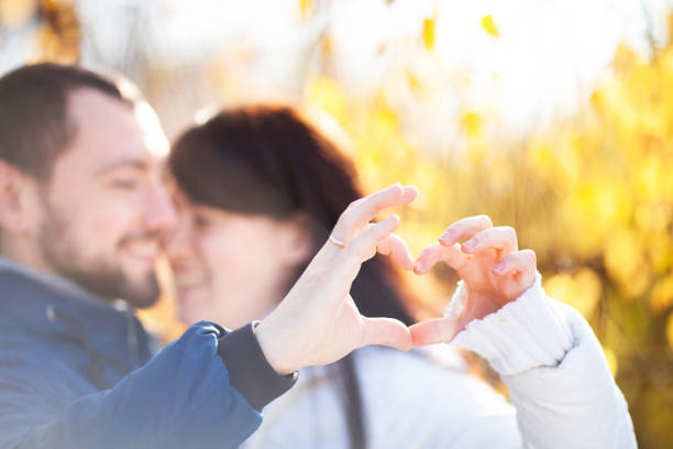 istock Lovely young couple makes a heart with their hands 988542038
