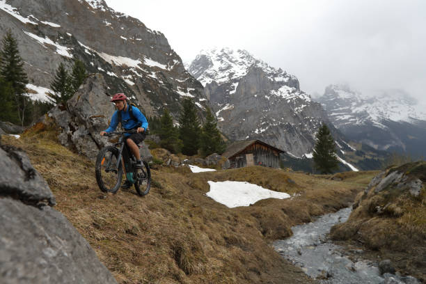 istock Mountain biker ascends trail above Grindelwald 988555232