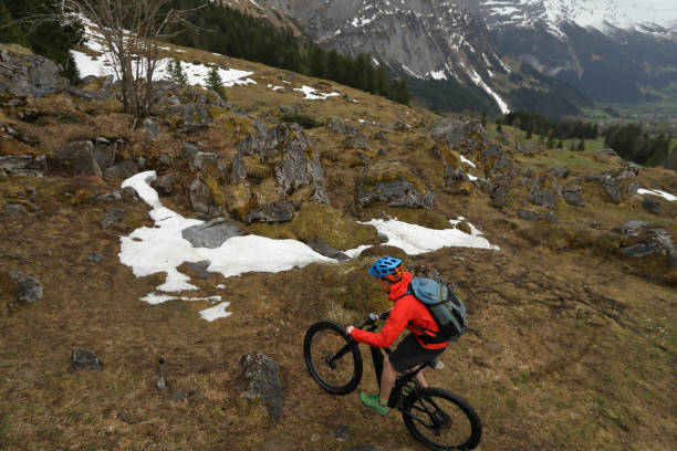 istock Mountain biker ascends trail above Grindelwald 988555248