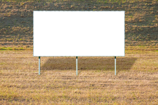 istock Blank advertising billboard in a field of dried grass - image with copy space 988556420