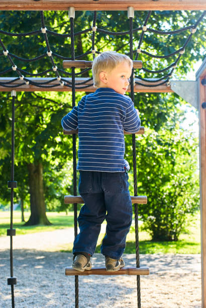 istock Little child boy having fun on the playground 988579274