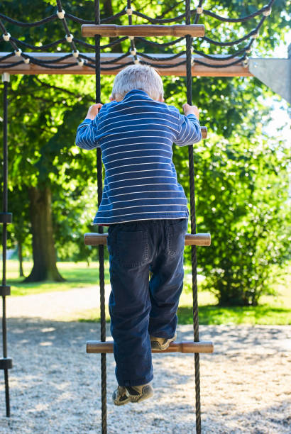istock Little child boy having fun on the playground 988579364