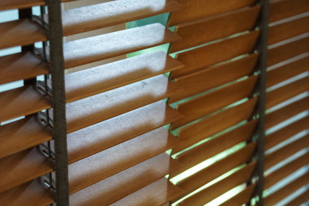 istock brown wood blind shade curtain and shadow 988585458