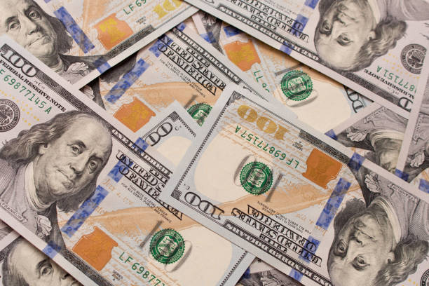 istock A lot of hundred dollar bills scattered on the table 988599526
