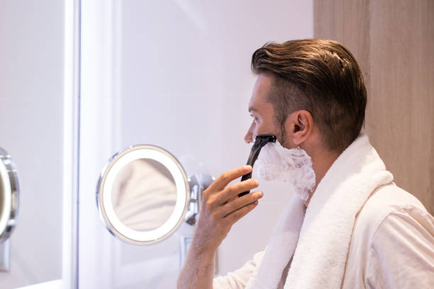 istock Man shaving in the morning in bathroom. 988631316